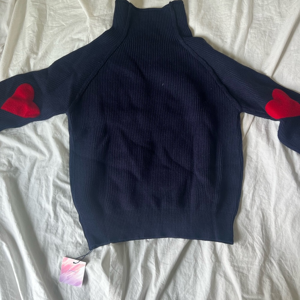 turtleneck sweater with hearts on elbows